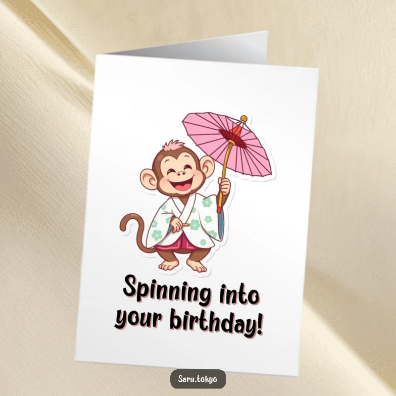 Funny Free Printable Birthday Card showing a joyful monkey in a traditional kimono playfully spinning a colorful parasol, radiating birthday cheer.